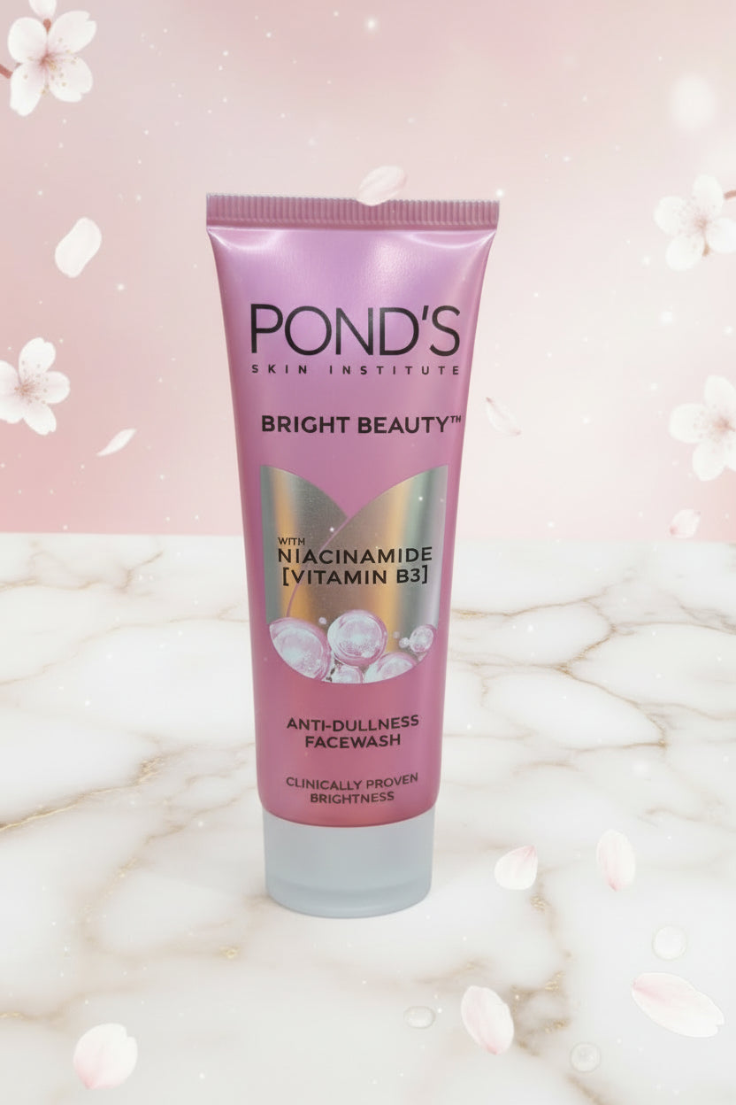 Hand holding a Pond's Bright Beauty skincare product with a blurred background